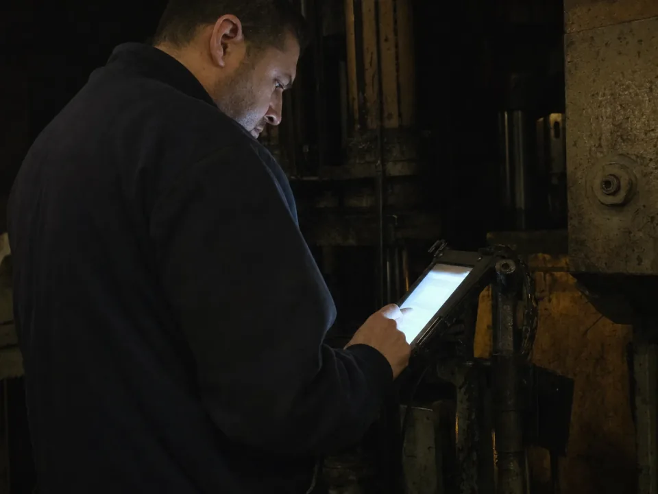 Veteran machinist explaining a setup to a younger colleague